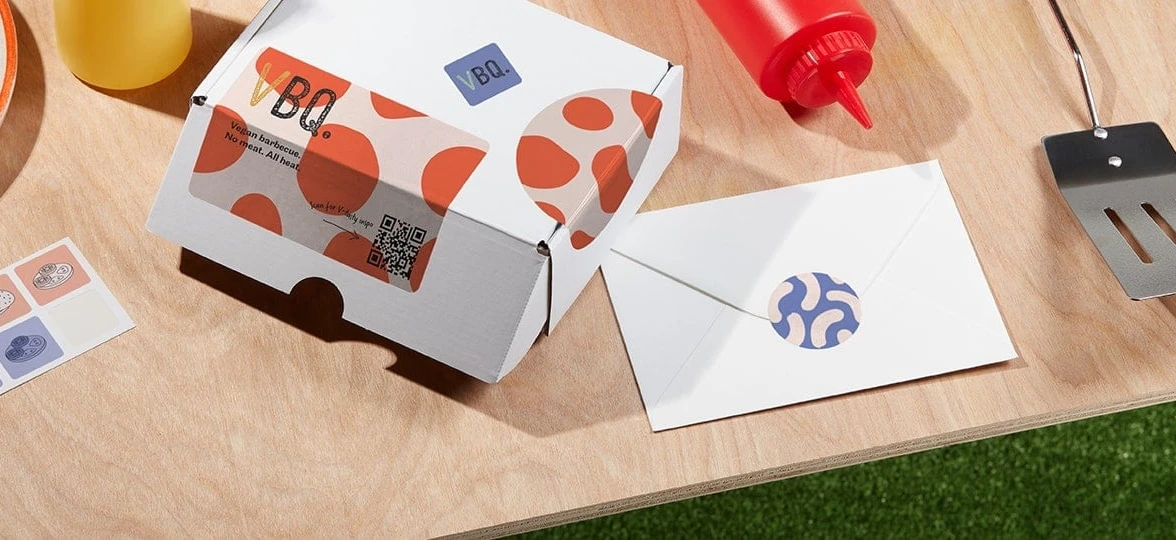 Custom printed packaging and envelopes with unique designs and QR codes.